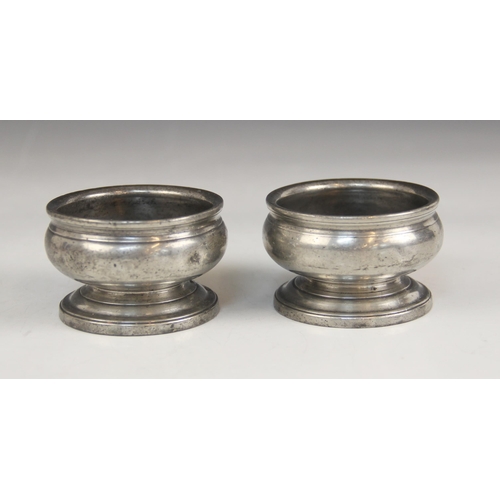 158 - A pair of early 19th century pewter salts, each of compressed circular form on pedestal foot, touch ... 