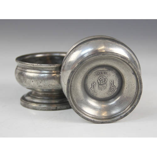 158 - A pair of early 19th century pewter salts, each of compressed circular form on pedestal foot, touch ... 