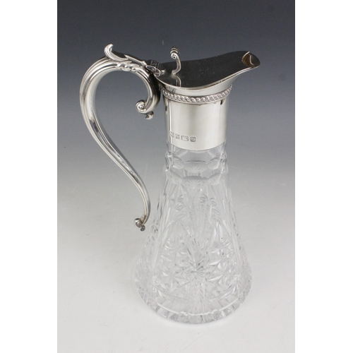 17 - A silver mounted cut glass claret jug, Barker Ellis Silver Co, Birmingham 1994, the tapering body wi... 