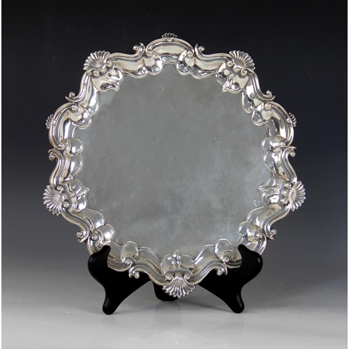 2 - An Edwardian silver salver, Barker Brothers, Birmingham 1903, of circular form with shell and scroll... 