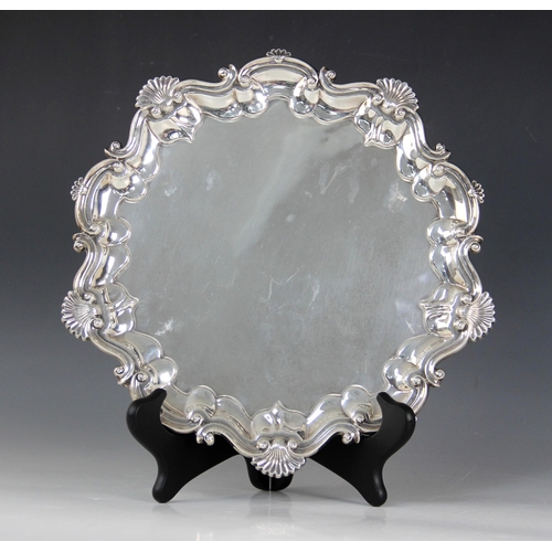 2 - An Edwardian silver salver, Barker Brothers, Birmingham 1903, of circular form with shell and scroll... 