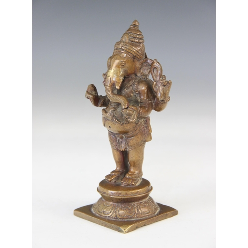 287 - An Indian bronze figure of Ganesh, early 20th century, modelled standing on a circular base and squa... 