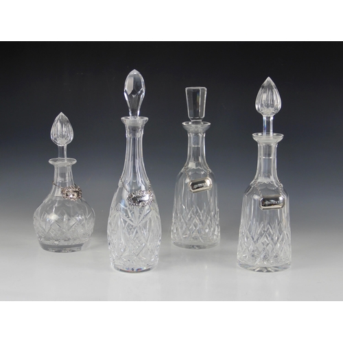 34 - Four early 20th century cut glass decanters with associated stoppers, measuring between (excluding s... 