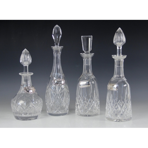34 - Four early 20th century cut glass decanters with associated stoppers, measuring between (excluding s... 