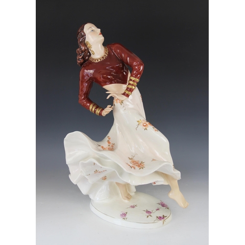 387 - A Royal Dux porcelain figure of a Flamenco Dancer, mid-20th century, dressed in maroon bodice and bi... 