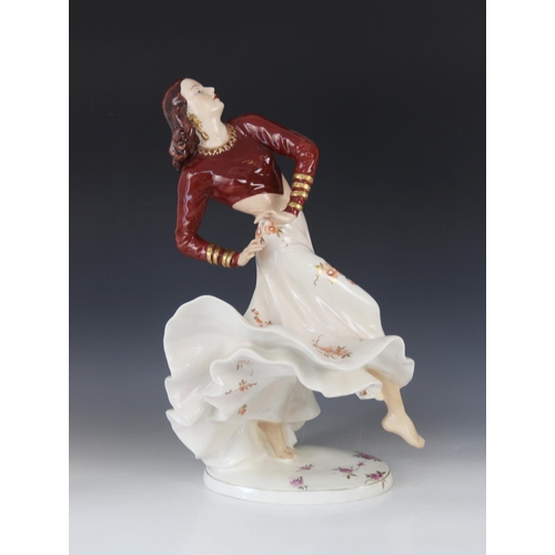 387 - A Royal Dux porcelain figure of a Flamenco Dancer, mid-20th century, dressed in maroon bodice and bi... 