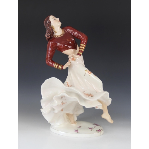 387 - A Royal Dux porcelain figure of a Flamenco Dancer, mid-20th century, dressed in maroon bodice and bi... 