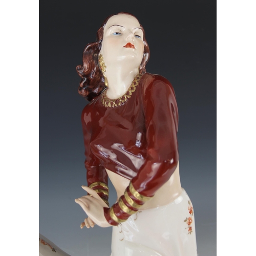 387 - A Royal Dux porcelain figure of a Flamenco Dancer, mid-20th century, dressed in maroon bodice and bi... 