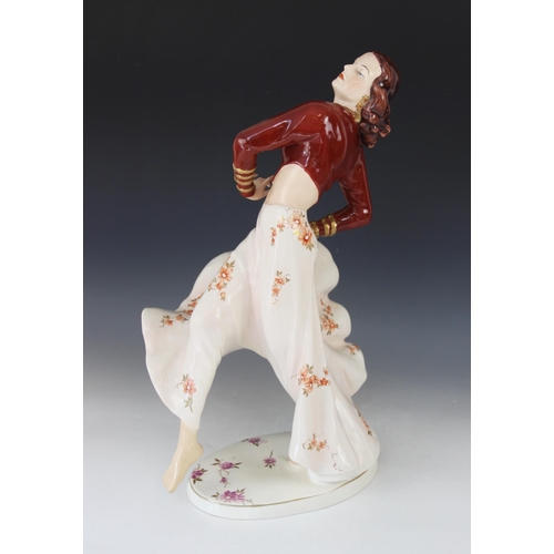 387 - A Royal Dux porcelain figure of a Flamenco Dancer, mid-20th century, dressed in maroon bodice and bi... 