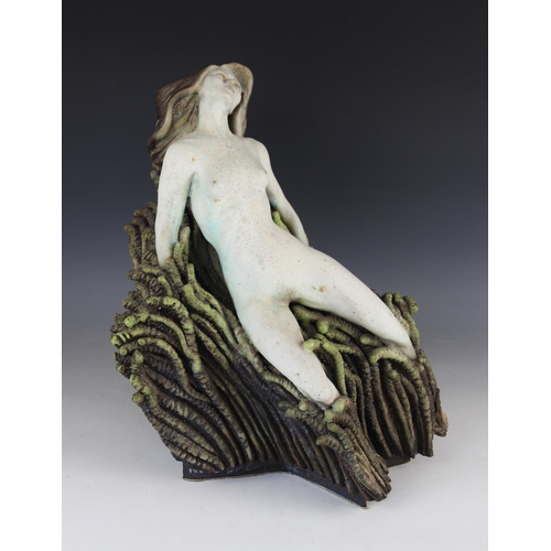 390 - Neil Dalrymple (b.1949), a sculpture of a nude upon a seaweed covered rocky outcrop, painted signatu... 