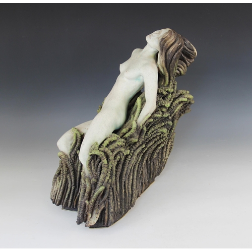 390 - Neil Dalrymple (b.1949), a sculpture of a nude upon a seaweed covered rocky outcrop, painted signatu... 