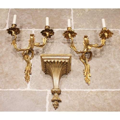 423 - A pair of French ormolu rococo style twin branch wall light fittings, each cast with scrolling inter... 