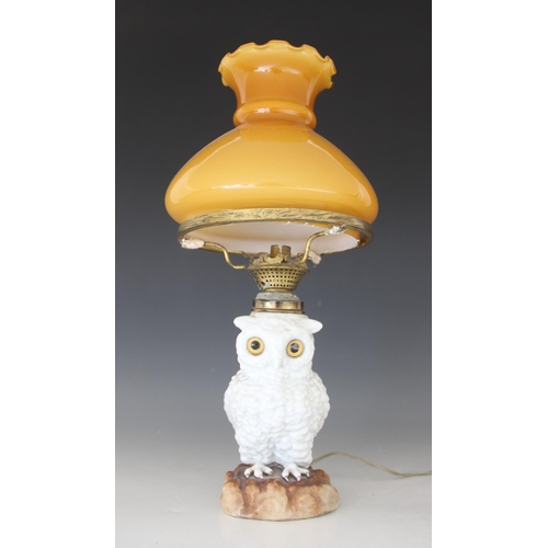 427 - A Staffordshire porcelain oil lamp modelled as a white owl, 19th century, the body forming the reser... 