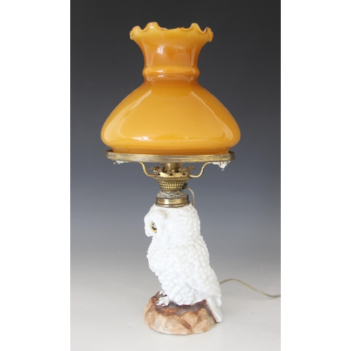 427 - A Staffordshire porcelain oil lamp modelled as a white owl, 19th century, the body forming the reser... 