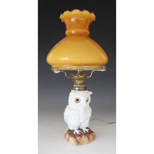 427 - A Staffordshire porcelain oil lamp modelled as a white owl, 19th century, the body forming the reser... 