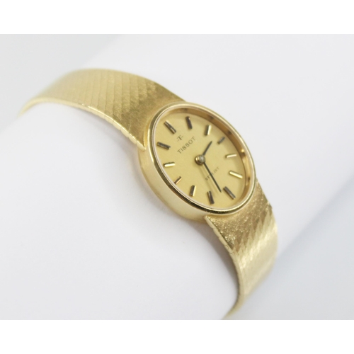 49 - A lady's Tissot Stylist 18ct gold wristwatch, the brushed gold coloured oval dial with baton markers... 