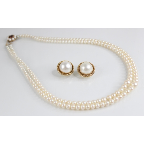 64 - A pearl necklace with 9ct gold clasp, comprising two rows of graduated cultured pearls, measuring be... 