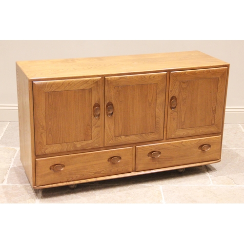 745 - A mid 20th century Ercol elm sideboard, formed from three cupboard doors over two drawers, the doubl... 