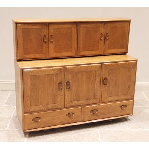 745 - A mid 20th century Ercol elm sideboard, formed from three cupboard doors over two drawers, the doubl... 