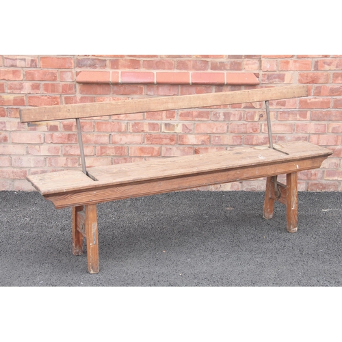 752 - A pitch pine railway platform bench, late 19th/early 20th century, the reversible back rest on iron ... 