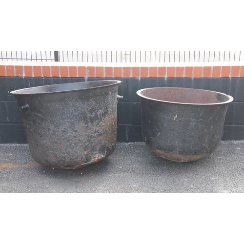 765 - Two Victorian cast iron wash pots/planters, each of typical domed form with a folded rim, 53cm H x 7... 