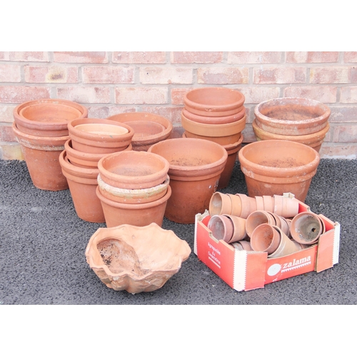 766 - A collection of terracotta plant pots, of typical tapering form, various sizes, the largest 25cm H x... 