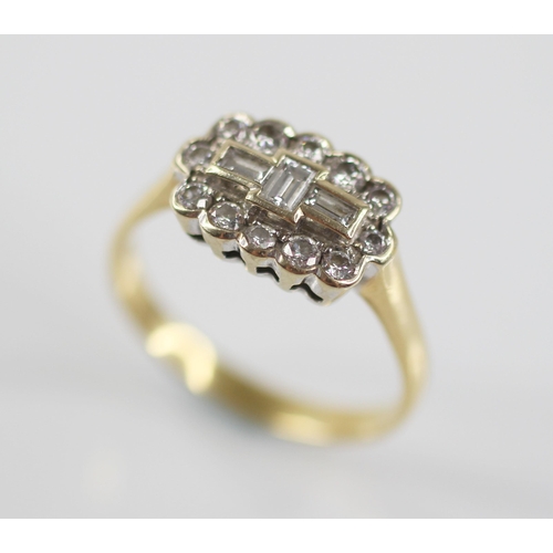 81 - A diamond 18ct gold cluster ring, the central boat shaped cluster designed as three baguette cut dia... 