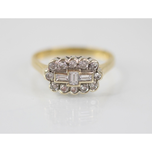 81 - A diamond 18ct gold cluster ring, the central boat shaped cluster designed as three baguette cut dia... 