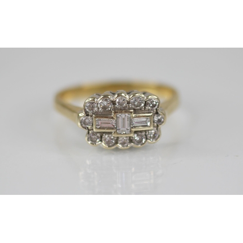 81 - A diamond 18ct gold cluster ring, the central boat shaped cluster designed as three baguette cut dia... 