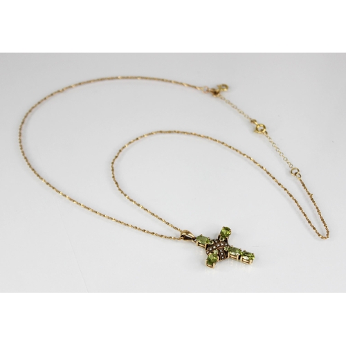 83 - A peridot and seed pearl 9ct Celtic cross pendant, comprising five oval mixed cut peridots to a seed... 