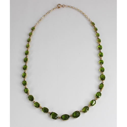 88 - A 19th century and later paste riviere necklace, designed as a single row of graduated oval green pa... 