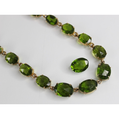 88 - A 19th century and later paste riviere necklace, designed as a single row of graduated oval green pa... 