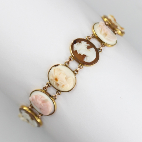 91 - a carved shell cameo gold coloured bracelet, comprising eleven oval carved shell cameos depicting fe... 