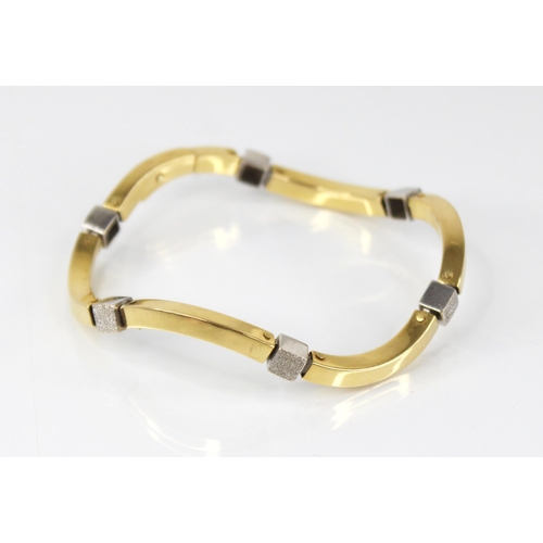 93 - A continental gold coloured bracelet, comprising six wave shaped plain polished yellow gold coloured... 