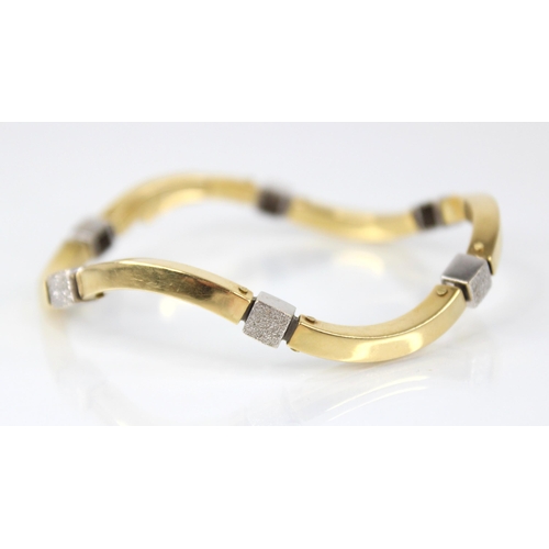 93 - A continental gold coloured bracelet, comprising six wave shaped plain polished yellow gold coloured... 