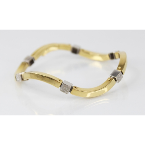 93 - A continental gold coloured bracelet, comprising six wave shaped plain polished yellow gold coloured... 