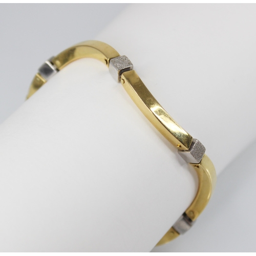 93 - A continental gold coloured bracelet, comprising six wave shaped plain polished yellow gold coloured... 