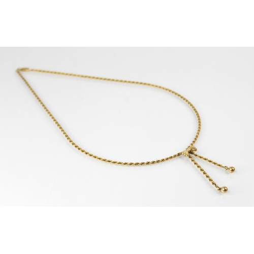 96 - A 9ct gold necklace, the rope twist chain with bow pendant suspending two beaded droppers, lobster c... 