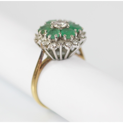 98 - An emerald and diamond floral cluster ring, the central round brilliant cut diamond with a 0.35 cara... 