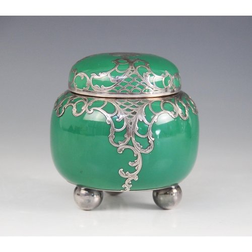 35 - A continental porcelain and silver plated overlaid tea caddy, modelled as a squat ginger jar with em... 