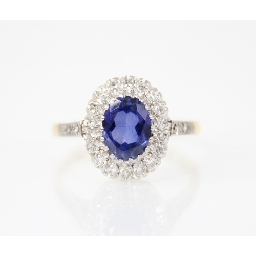 60 - A synthetic sapphire and diamond 18ct gold ring, the central oval mixed cut tanzanite measuring 8mm ... 