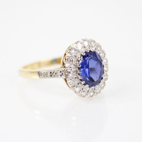60 - A synthetic sapphire and diamond 18ct gold ring, the central oval mixed cut tanzanite measuring 8mm ... 