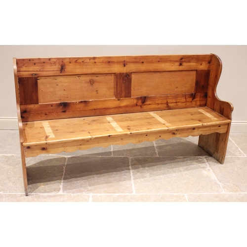 739 - A pine settle, 20th century, the panelled back above a board seat upon shaped end supports, 99cm H x... 