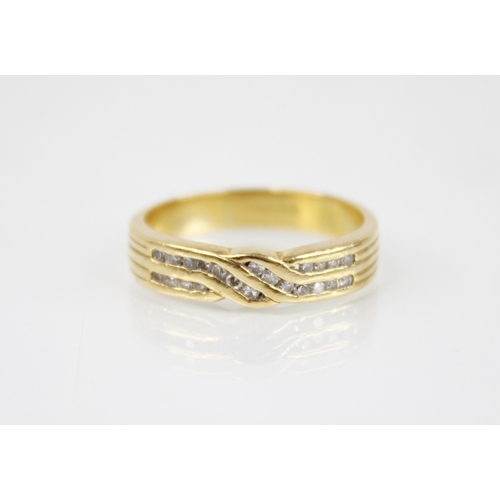 116 - An 18ct gold diamond crossover ring, the designed as two rows of single cut diamonds, channel set in... 