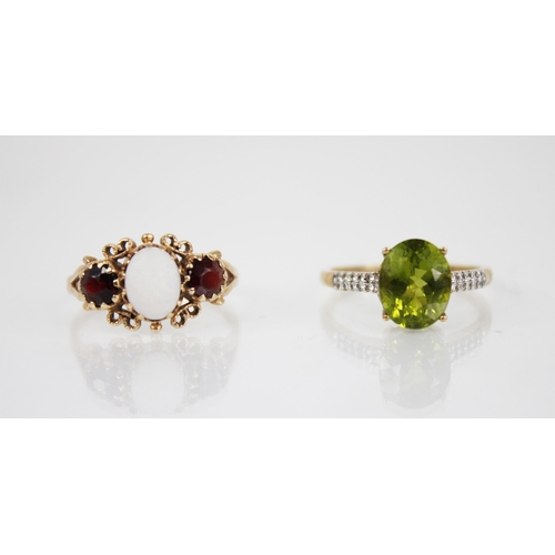 141 - A peridot 9ct gold cocktail ring, the central oval mixed cut peridot measuring 10mm x 8mm, claw set ... 