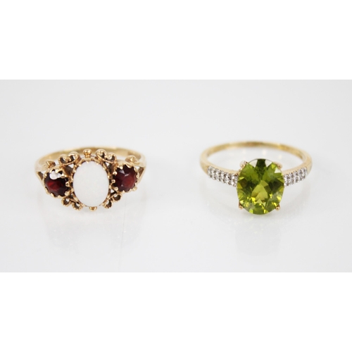 141 - A peridot 9ct gold cocktail ring, the central oval mixed cut peridot measuring 10mm x 8mm, claw set ... 