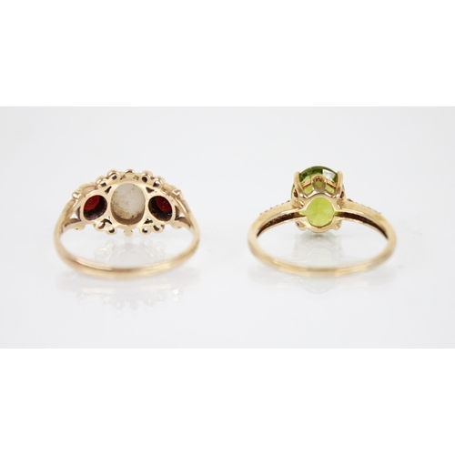 141 - A peridot 9ct gold cocktail ring, the central oval mixed cut peridot measuring 10mm x 8mm, claw set ... 