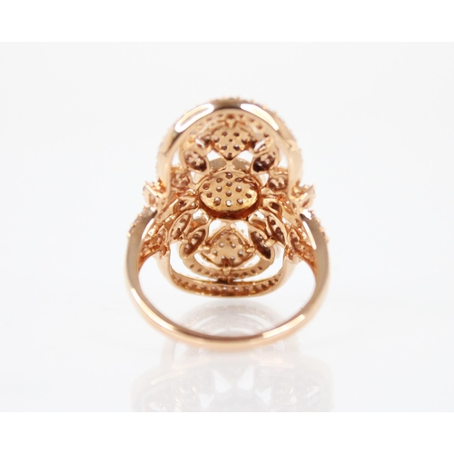 142 - A diamond and 18ct rose gold ring, the oval shaped head with pierced foliate detail, milgrain set wi... 