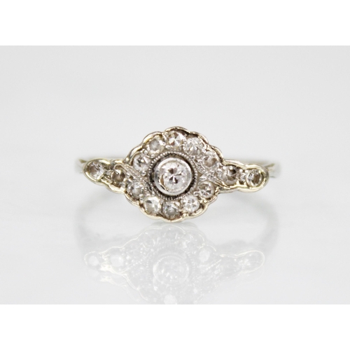 146 - An Edwardian diamond cluster ring, the central old cut diamond approximately 2.30mm diameter, with f... 