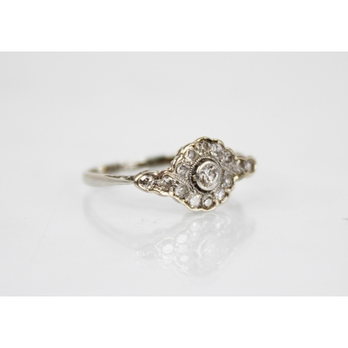 146 - An Edwardian diamond cluster ring, the central old cut diamond approximately 2.30mm diameter, with f... 